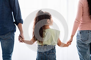 Family Support Concept. Little Girl Holding Hands With Mom And Dad, Closeup