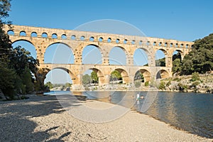 Family swimming in the GardÃ³n river, very close to the Roman aqueduct Pont du Gard.  France, Europe