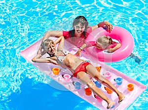 Family in swimming pool.