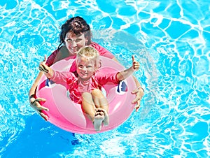 Family in swimming pool.