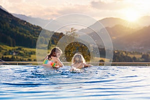 Family in swimming pool with mountain view