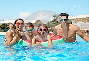 Family in swimming pool. Summer vacation