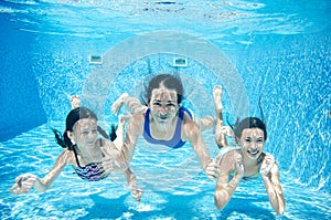Family swims in pool underwater, happy active mother and children have fun under water, fitness and sport with kids