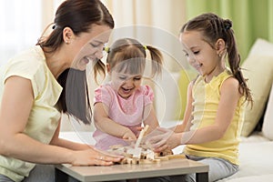 Family at the table playing board game