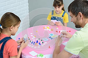 Family at the table plays card board games