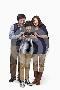Family taking picture with digital camera, studio shot