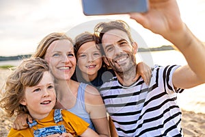 Family taking self portrait on beach