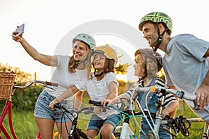 Family taking a selfie while on a bike ride