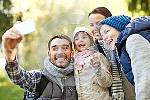 Family taking selfie with smartphone outdoors