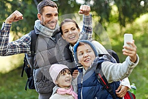 Family taking selfie with smartphone in woods