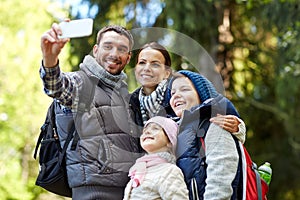 Family taking selfie with smartphone in woods