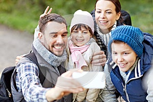 Family taking selfie with smartphone in woods