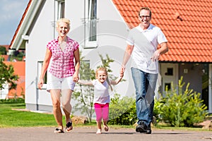 Family taking walk in front of home