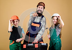 Family teamwork. Repair. Bearded man with little girls. construction worker assistant. Builder or carpenter. Repairman