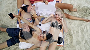 Family teenagers lying on beach and having fun