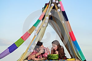 Family in tent. Couple in love hugging and kissing in camping. Smoking man eating woman at picnic outdoor.