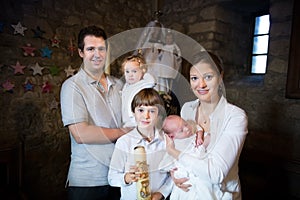 Family with three children celebrating the baptism