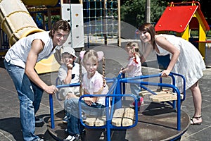 Family and three children in park.