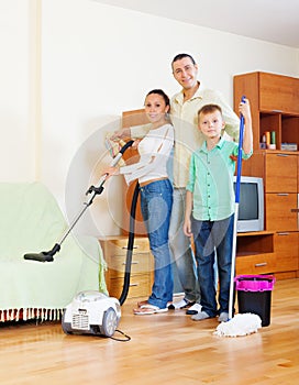 Family of three with cleaning equipment