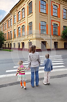 Family of three and crossing road