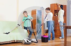 Family of three doing cleaning
