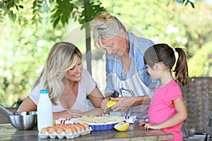 Family of three generations preparing apple pie