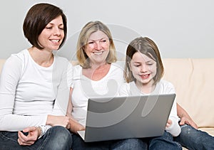 Family of Three Generations using a Laptop