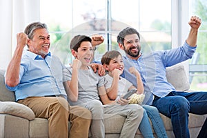 Family of three generations watching tv