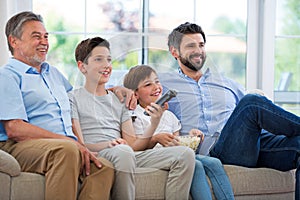 Family of three generations watching tv