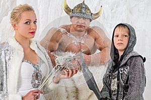 Family of three in historical costume viking with