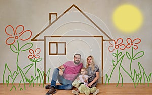 Family of three inside drawn house with flowers and conceptual sun. Dreaming of a home. Life achievement