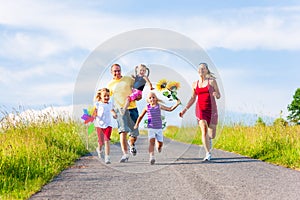 Family with three kids running