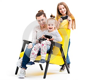 Family playing computer games with joystick