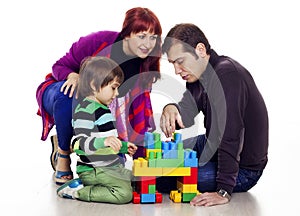 Family of three playing lego