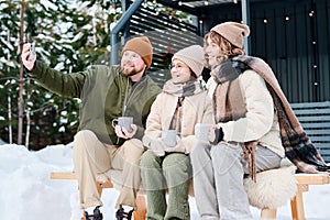 Family Of Three Taking Selfie Outdoors On Winter Day