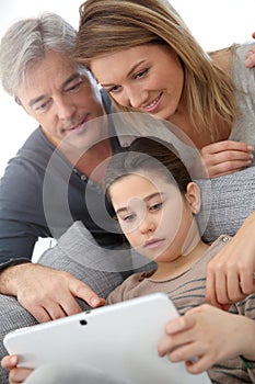 Family of three websurfing on internet photo