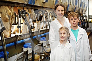 Family of three in white robes and machines for