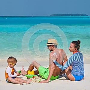 Family with three year old boy on beach