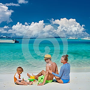 Family with three year old boy on beach