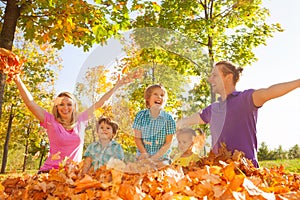 Family throwing leaves in the air during play