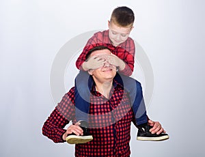 Family time. Best friends. Father little son red shirts family look outfit. Child riding on dads shoulders. Happiness