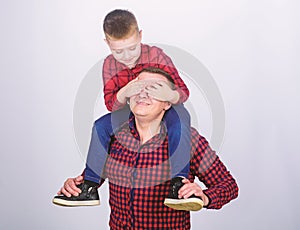 Family time. Best friends. Father little son red shirts family look outfit. Child riding on dads shoulders. Happiness