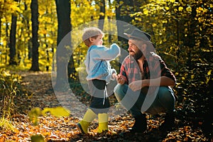 Family time. Brutal bearded man and little boy enjoy autumn nature. Family leisure. Family values. Explore nature