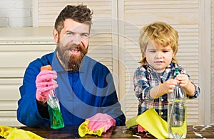 Family time concept. Dad with son and cleaning supplies. Father and kid having fun during cleaning. Man with child plays