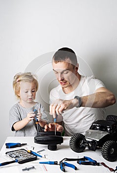 Family time: Dad and daughter repair the rc radio controlled buggy car model and lead a video blog.