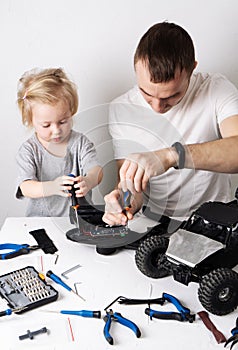 Family time: Dad and daughter repair the rc radio controlled buggy car model and lead a video blog.