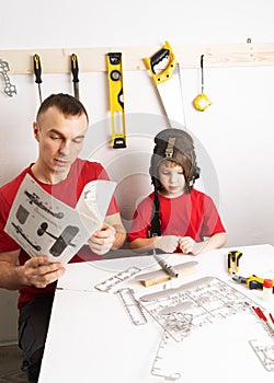 Family time: father and son assemble a large-scale model of the aircraft according to the assembly scheme.