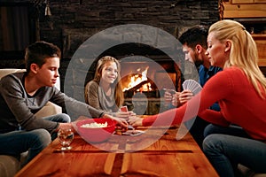 Family time- parents and children playing cards at home