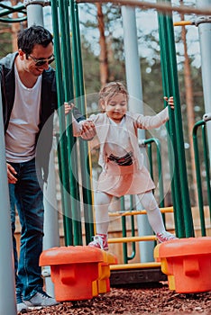 Family time in the park. Father have fun with his daughter in the park, playing fun games and spending time together