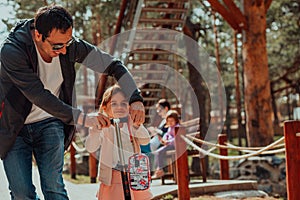 Family time in the park. Father have fun with his daughter in the park, playing fun games and spending time together